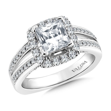 An exquisitely crafted cushion shape halo surrounding a princess cut diamond engagement ring.