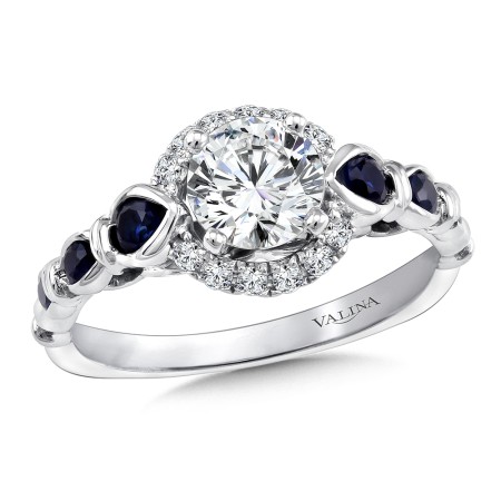Give your bride to be a splash of color with this diamond and blue sapphire halo engagement ring.