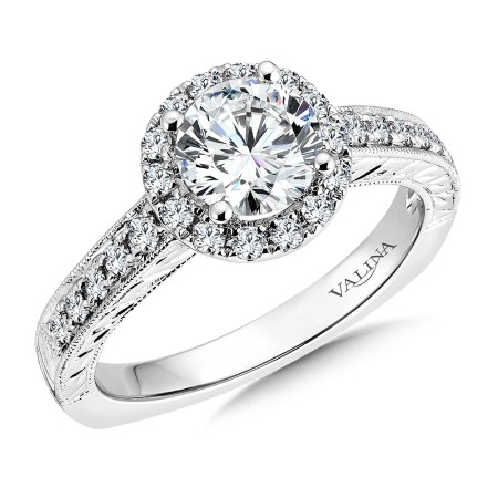 Round halo-style diamond engagement ring in 14k white gold.