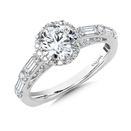 The center stone shines magnificently next to its petite prong-set halo and baguette accented shoulders. R1062W