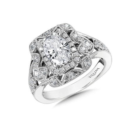 An elongated halo of sparkling diamonds encases a beautiful oval center stone. An additional decorative and open-hole halo frames the initial halo with milgrain beading and a unique rounded pattern - the shank shares these intricate design details. R1063W